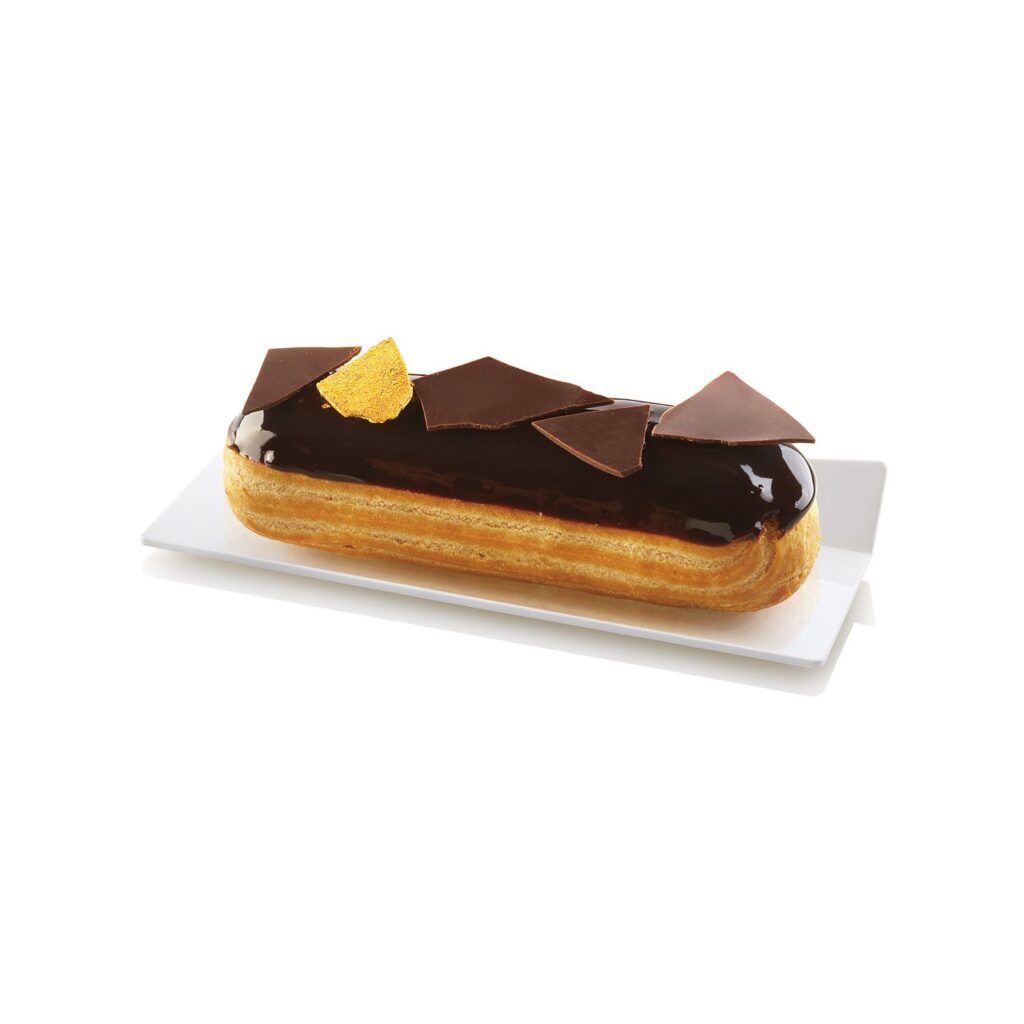 Glazed éclair presented on a white rectangular dessert tray