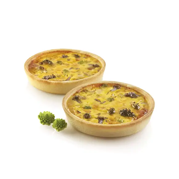 Two round savoury vegetable tarts with crisp golden pastry shells