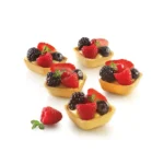 Five square fruit tartlets with raspberries, blackberries, blueberries and strawberries