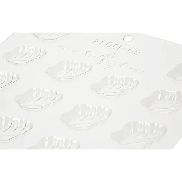 Close-up of transparent Silikomart chocolate mould with detailed leaf-shaped cavities