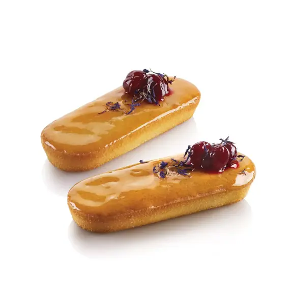 Two glazed oblong cakes with cherries made using the Silikomart Airplus 32 Midi Plumcake mould