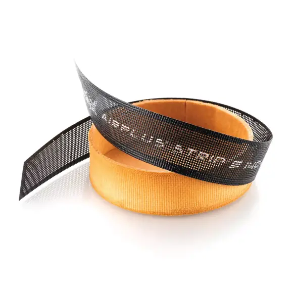 Black Silikomart Airplus microperforated strip wrapped around a baked round tart shell