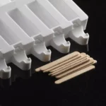 Natural Silikomart mini wooden ice cream sticks beside a professional ice-pop mould