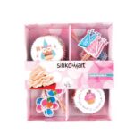 Silikomart box containing colourful party paper baking cases and matching cupcake topper picks