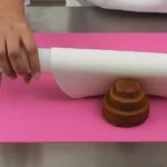 Silikomart RP05 mini rolling pin flattening white decorative paste on a pink pastry mat