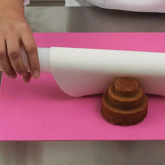 Silikomart RP05 mini rolling pin flattening white decorative paste on a pink pastry mat