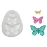 White Silikomart SLK306 silicone mould with three butterfly cavities and colourful finished butterflies