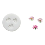 White Silikomart SLK361 silicone mould with three miniature flower cavities and finished pink flowers