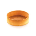 Empty golden round tart shell with straight textured sides baked using an Airplus Strip