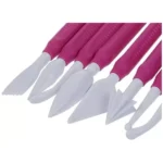 Close-up of assorted white shaping tips on fuchsia Silikomart modelling tools